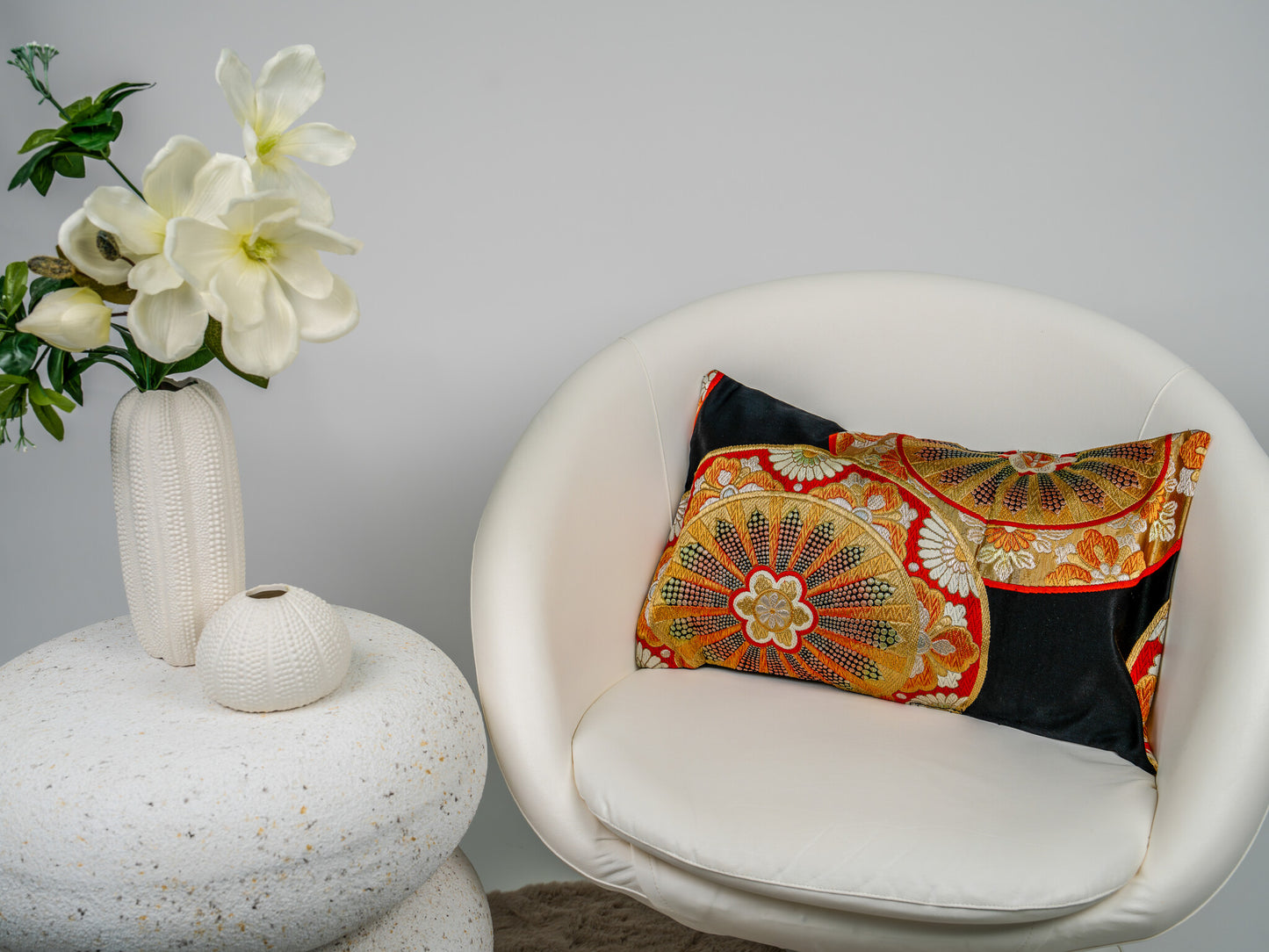 Japanese ceremonial silk lumbar pillow with genji-guruma carriage wheel in black and gold — Renaras atelier