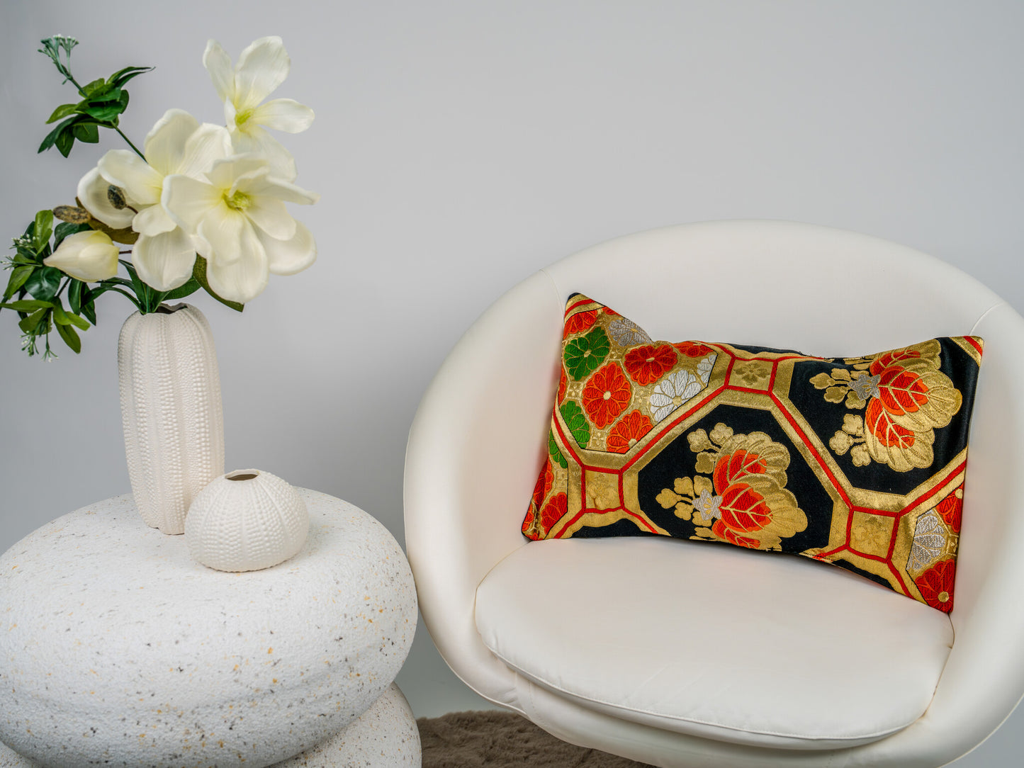 Japanese ceremonial silk lumbar pillow with kiri paulownia crest in black and gold — Renaras atelier