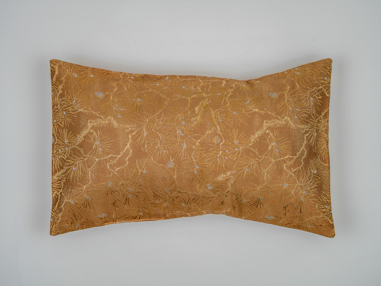 Vintage ceremonial silk lumbar pillow in copper and gold with imperial Kiku chrysanthemum motif, made from a Showa-era fukuro obi by Renaras, an Amsterdam atelier.