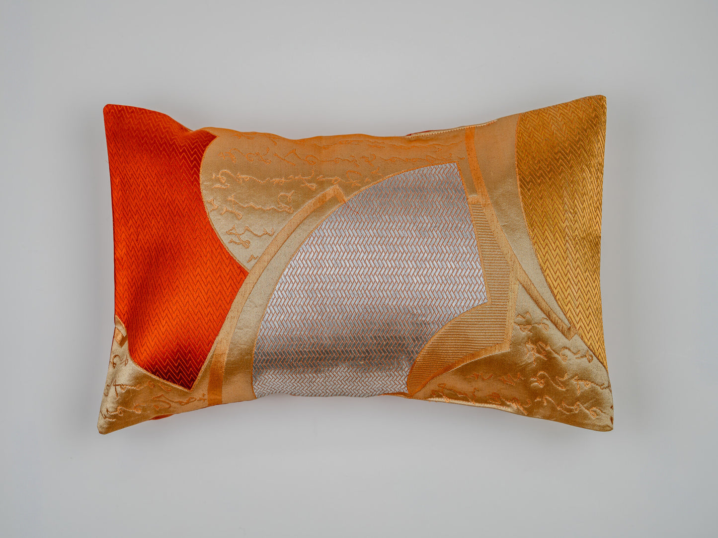 Japanese ceremonial silk lumbar pillow with herringbone chevron in persimmon and silver — Renaras atelier