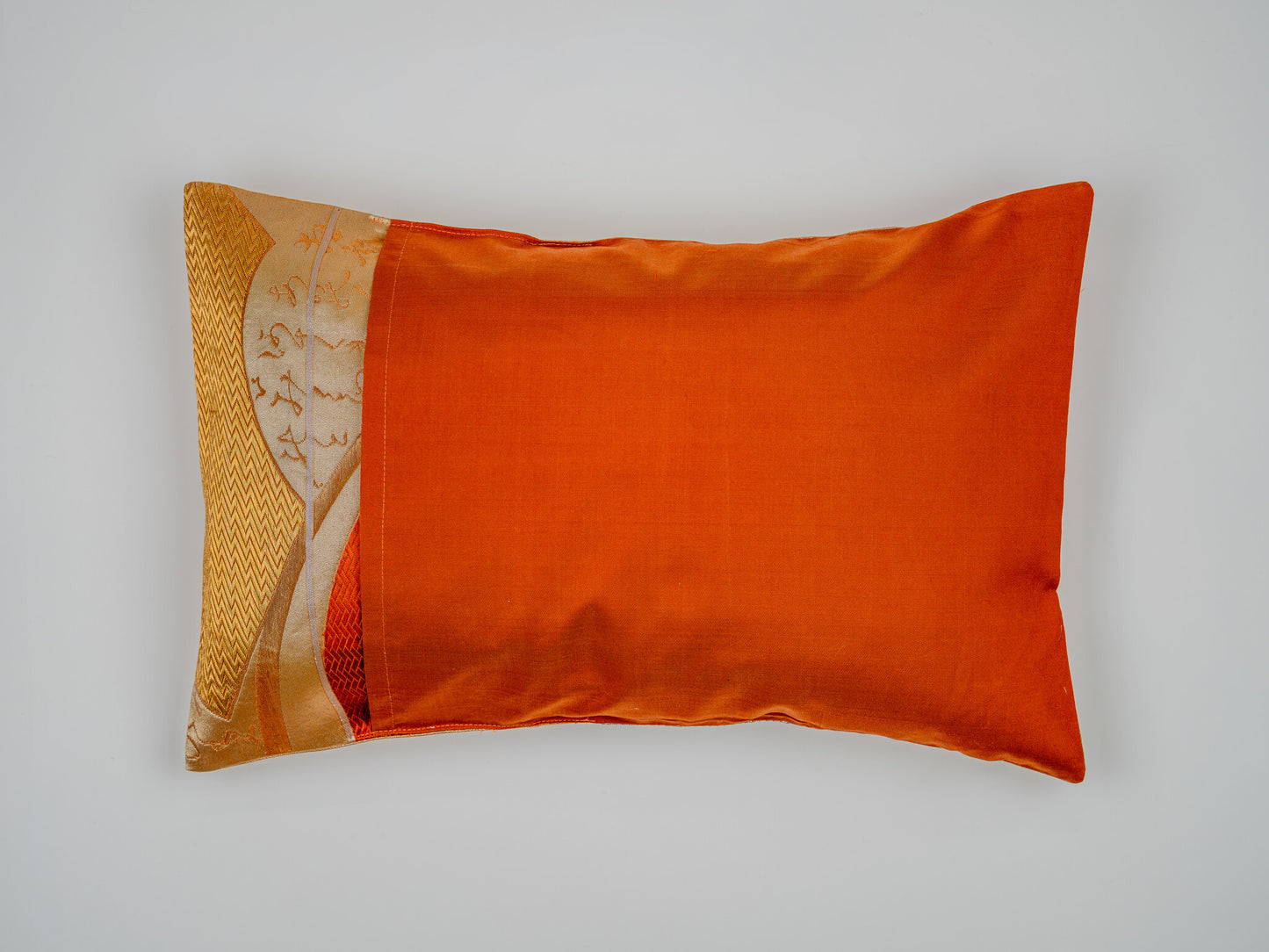 Japanese ceremonial silk lumbar pillow with herringbone chevron in persimmon and silver — Renaras atelier
