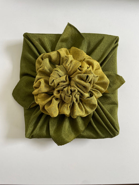 Gift wrapped in an olive green cotton furoshiki, tied by hand at the Renaras atelier in Amsterdam